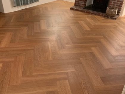 Parquet Flooring in a lounge with fireplace