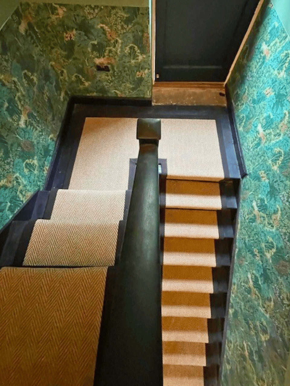 Roger Oats Stairs Carpet - beige carpet on black stairs with green wallpaper