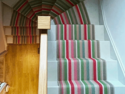 Roger Oats Stairs Carpet - red, green and beige carpet, down sandy coloured staris in old home.