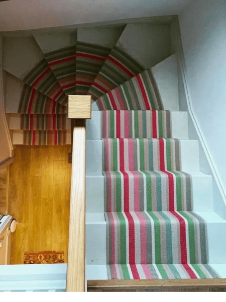 Roger Oats Stairs Carpet - red, green and beige carpet, down sandy coloured staris in old home.